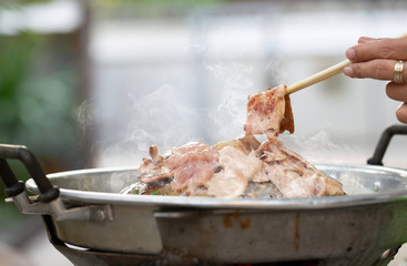 Grilling sliced pork and meat on hot pan (Pan Pork) asian style with ingredients and sauce