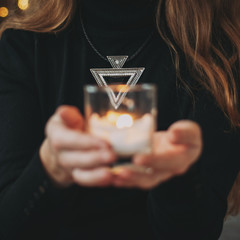 Wall Mural - Blurred candle candle on girl background.