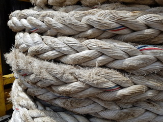 Hawser mooring rope coiled on deck of a construction work barge at oil field