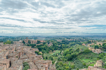 Wall Mural - Beautiful aerial panoramic view of Old Town of medieval city of Siena in the cloudy autumn day, Tuscany, Italy