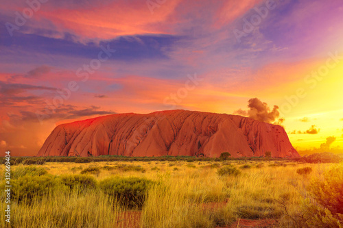 Cuadros en Lienzo Colorful clouds at sunset sky over Ayers Rock in Uluru-Kata Tjuta National Park - at Living Cultural Landscape, Australia, Northern Territory
