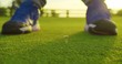 Golfer hiting golf ball down in hole in beautiful golf course on bright sunset.Golf sport concept. Closeup.