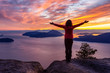 © edb3_16 - Adventurous Caucasian Girl standing on top of a mountain during a colorful winter sunset. Taken on Tunnel Bluffs Hike, North of Vancouver, BC, Canada.