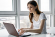 © SHOTPRIME STUDIO - young woman working on laptop at home