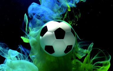 Soccer ball on a fantastic blue and green space background.