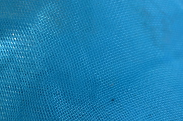 The surface of the blue net used in fishing
