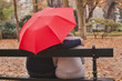 comforting and psychological support, care concept, man hugs woman under umbrella in autumn park