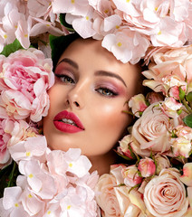Wall Mural - beautiful white girl with flowers. stunning brunette girl with big bouquet flowers of roses. closeup