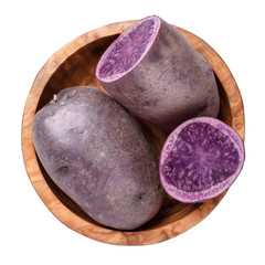 Wall Mural - Raw purple potatoes in wooden bowl isolated on white background. Top view.