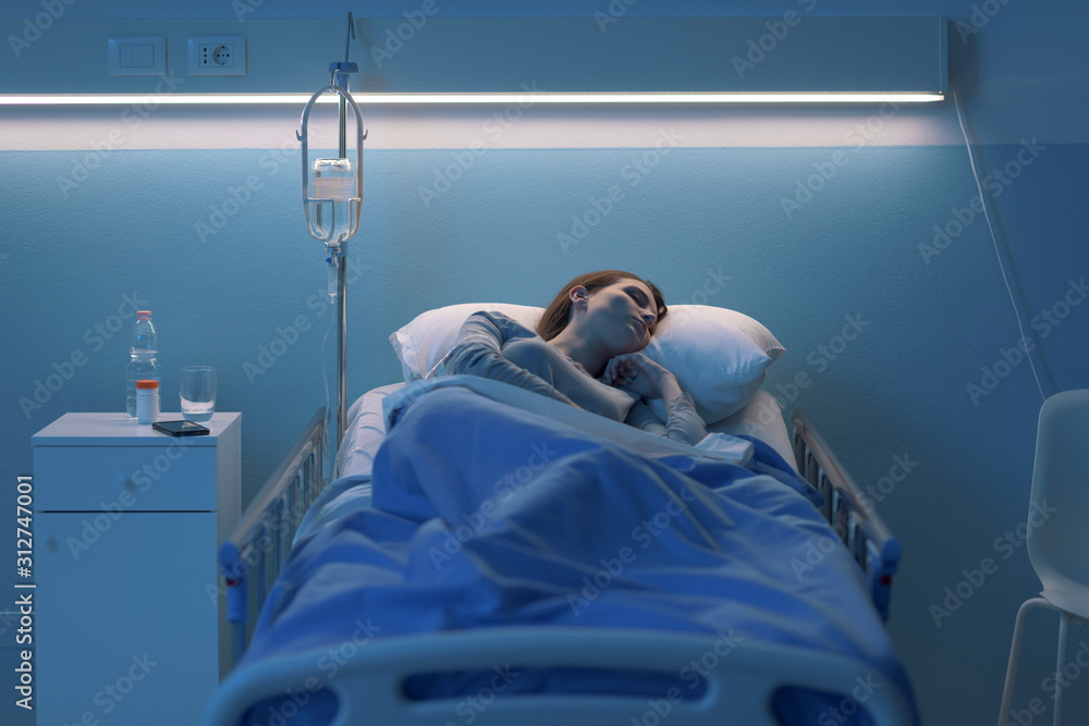Woman lying in the hospital bed and sleeping with IV drip Stock Photo ...