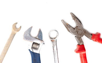 Adjustable wrenches and pliers isolated on a white