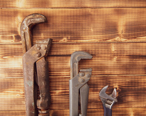 Adjustable wrenches on a wooden background