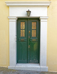 house entrance green door with white frame, Athens Greece, Plaka neighborhood