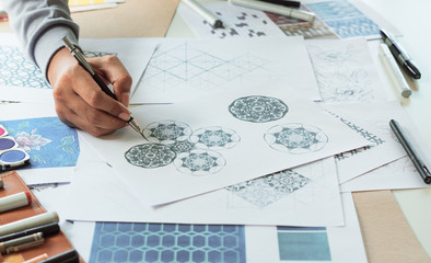 Wall Mural - Designer designing drawing sketch pattern geometric flower seamless wallpaper fabric textile fashion industry. artistic design studio..