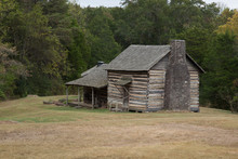 Weathered Log Cabin With A Porch