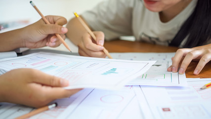 Wall Mural - asian startup web app designer team creating user experience ux on smartphone layout to design appli