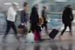 © Pink Badger - People with suitcases in blurred motion at airport or railway station