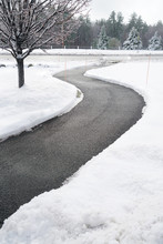Winding Pedestrian Sidewalk With Snow Removed After Winter Snow