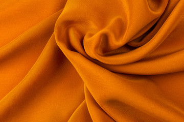 Golden silk or satin luxury fabric texture can use as abstract background.