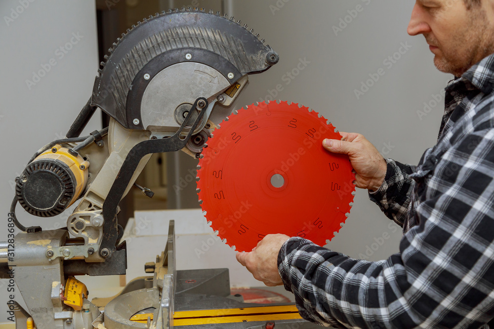 Carpenter replacing a rotary cutters blade in the saw Stock Photo ...