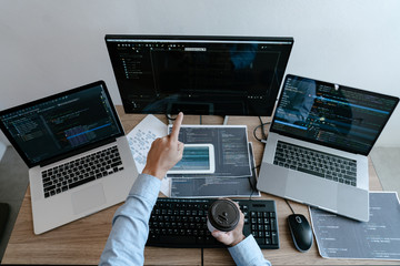 Wall Mural - programmer typing code on desktop computer, developing programming and coding technologies concept.