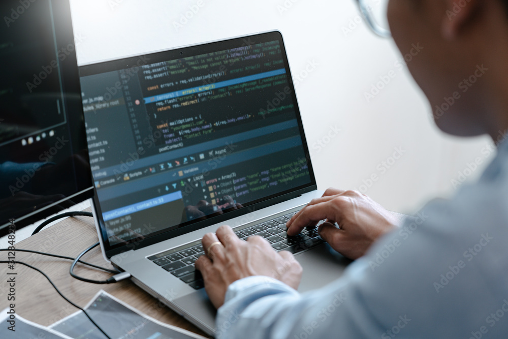 Programmer Typing Code on desktop computer, Developing programming and coding technologies concept.