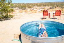 A Girl Submerges Underwater In A Small Outdoor Tub Pool