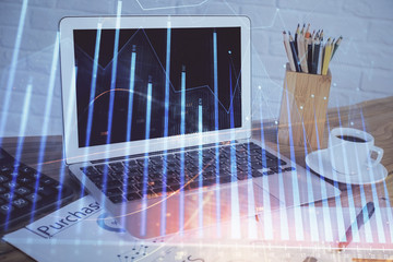 Stock market graph and table with computer background. Double exposure. Concept of financial analysis.