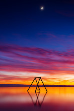 Colorful Sunset And Swing Set In The Water At The Salton Sea