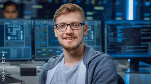 Cuadros en Lienzo Portrait of a Smart and Handsome IT Specialist Wearing Glasses Smiles, Behind Hi