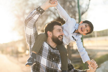 Father Playing With Son In Outdoors Image