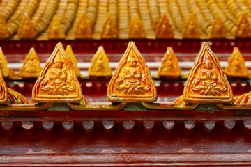 Wall Mural - orange roof tiles on buddhist temple with design of buddha 