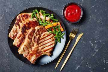 Canvas Print - Grilled pork loin cutlets on a plate