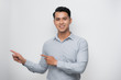 © makistock - Young asian man cheerful with a smile of face pointing with hand and finger up to the side with happy and natural expression