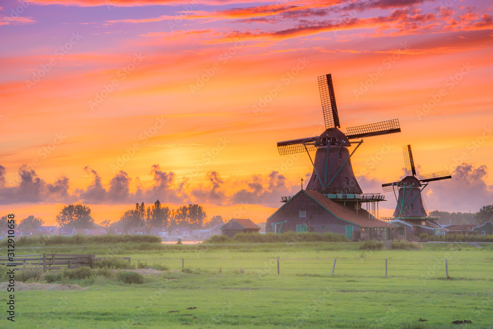 Traditional village with dutch windmills and river at sunset, Holland, Netherlands. - obrazy, fototapety, plakaty 