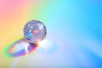 Crystal prism Refracting light in vivid rainbow colors. Refractions of light in glass prism. glass prism on holographic background. close up. copy space