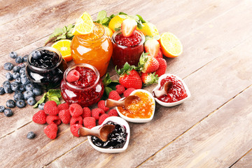 Wall Mural - assortment of jams, seasonal berries jelly, mint and fruits and tangerine