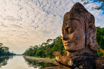 Details of Stone faces sculpture and rock carvings at gate of Bayon wat in Angkor Thom temple, world famous travel destination, Cambodia and siem reap tourism. Buddhism meditation concept.