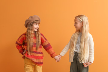 Sticker - Cute little girls in autumn clothes on color background