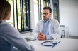 © bnenin - Portrait of attentive doctor listening to a patient.