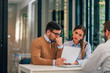© bnenin - Worried couple looking at paper document in the office of financial adviser.