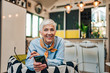 © bnenin - Portrait of a charming senior woman with smart phone at home, looking at camera.