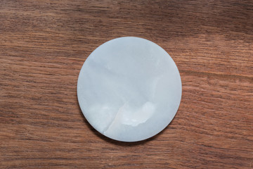 White marble dish on wood table