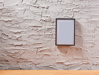 Wall Mural - Decorative textured grey stone wall, wooden desk and frame, home ornament detail.