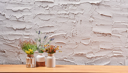 Wall Mural - Grey textured wall background and home design vase of flower book and frame on the wood desk interior.