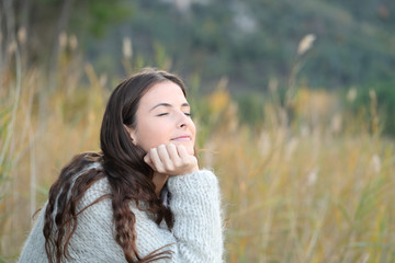 Wall Mural - Relaxed girl breathing fresh air in the mountain