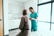 © Gerald Carter/Creative Flame - Nurse listening to stethoscope on patient's back