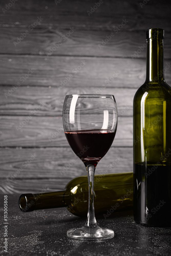 Bottles and glass of wine on table. Concept of alcoholism