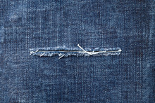 Close-up of torn jeans textured backround