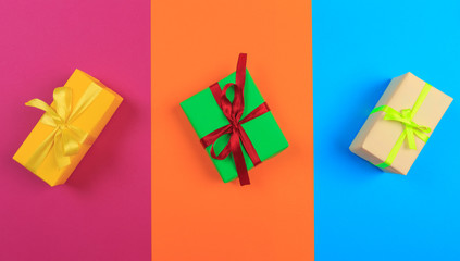 Wall Mural - Different colored gift box on color background. Top view of various present boxes on minimal background. Birthday, Christmas, wedding, valentine, romantic gifts - Image